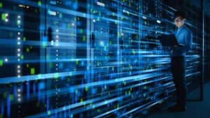 shot of asian it specialist using laptop in data center full of rack servers concept of high